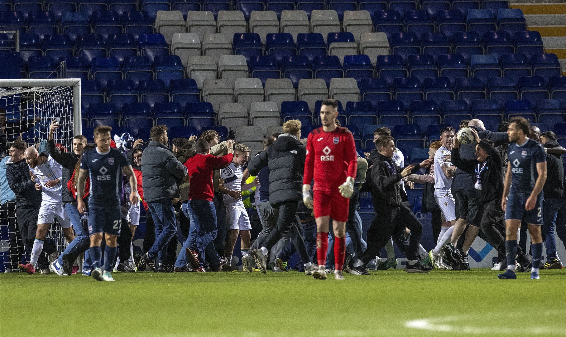Despondent Ross County players could only watch as Dundee's fans and players celebrated last Saturday. Picture: Ken Macpherson