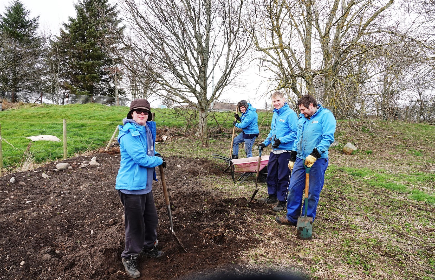 Blooming Gardeners clearing the ground for the wild flower meadow.