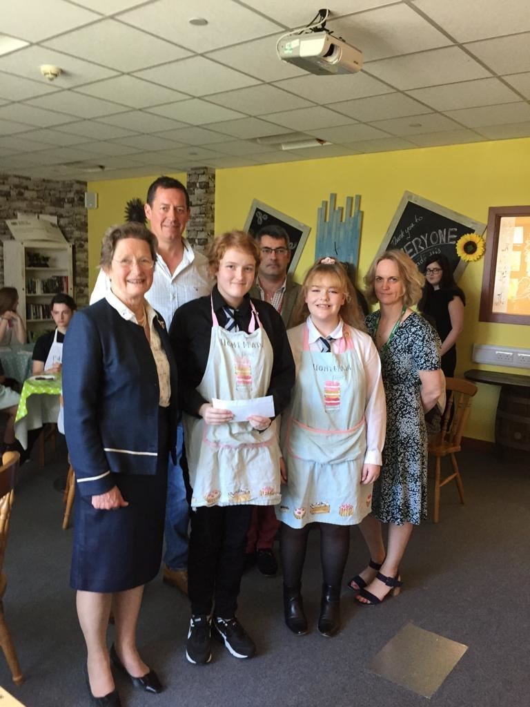 The Scotland Burger made by Shaunna Urquhart and Kaya MacDonald, with the judges and teacher Leanne Sumner in the background, will go on sale.