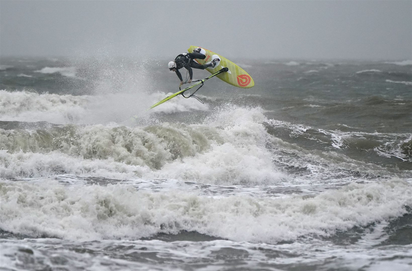But such conditions are perfect for some – with this wind surfer making the most of the weather in Bracklesham Bay, West Sussex (PA)