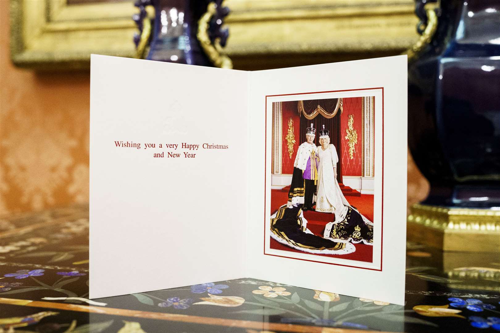 Charles and Camilla have chosen a formal coronation image for their Christmas card (Buckingham Palace/Hugo Burnand/PA)