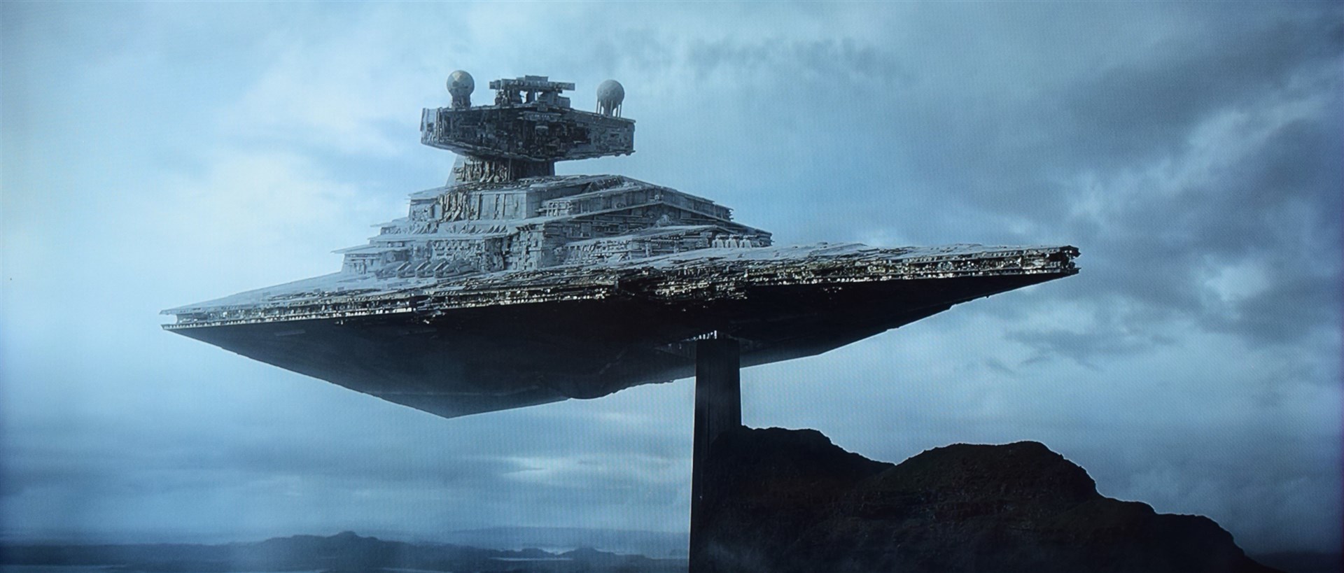 Grand Admiral Thrawn's Star Destroyer hovers above Suilven (doubling in for a Nightsisters temple) in an early establishing shot. ©2023 Lucasfilm Ltd. & TM. All Rights Reserved.