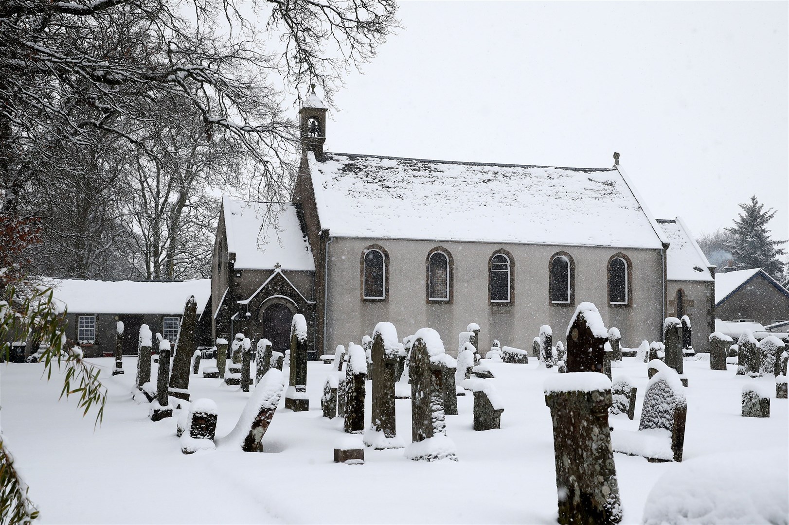 Snow covers the church and graveyard in Braco, near Dunblane in Scotland (Andrew Milligan/PA)
