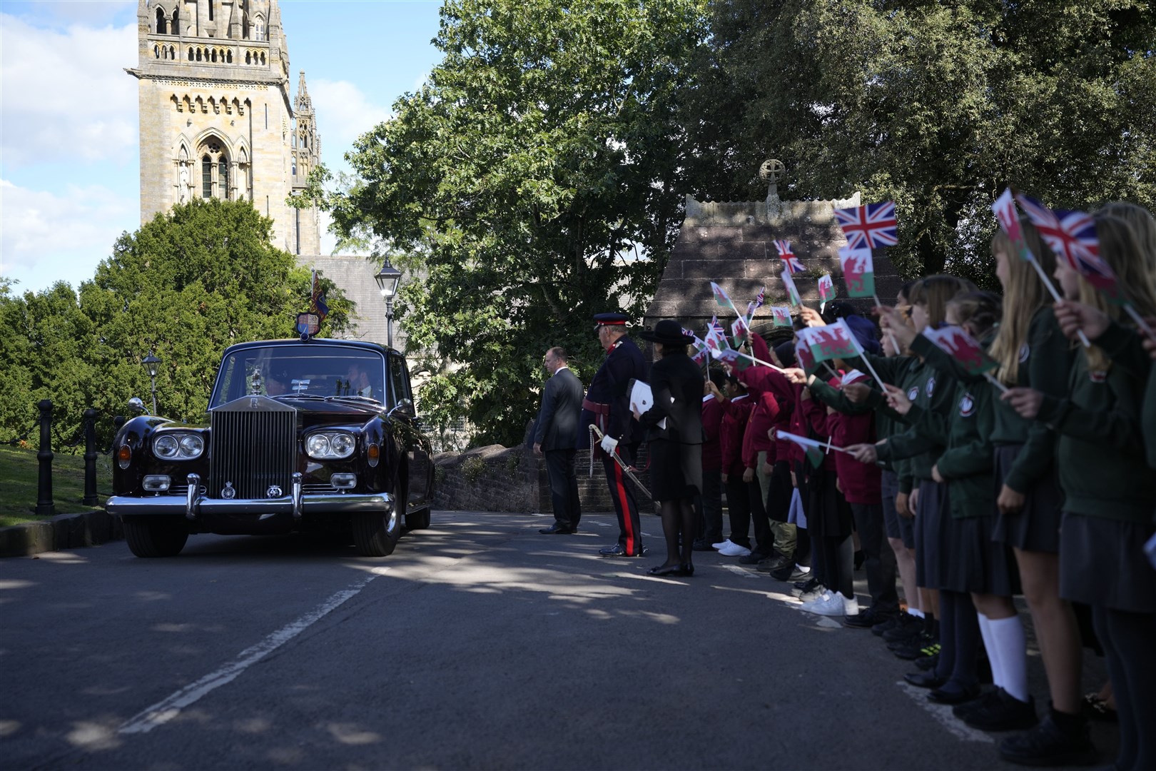 Crowds cheer as the royal couple drive through Cardiff (Frank Augstein/PA)
