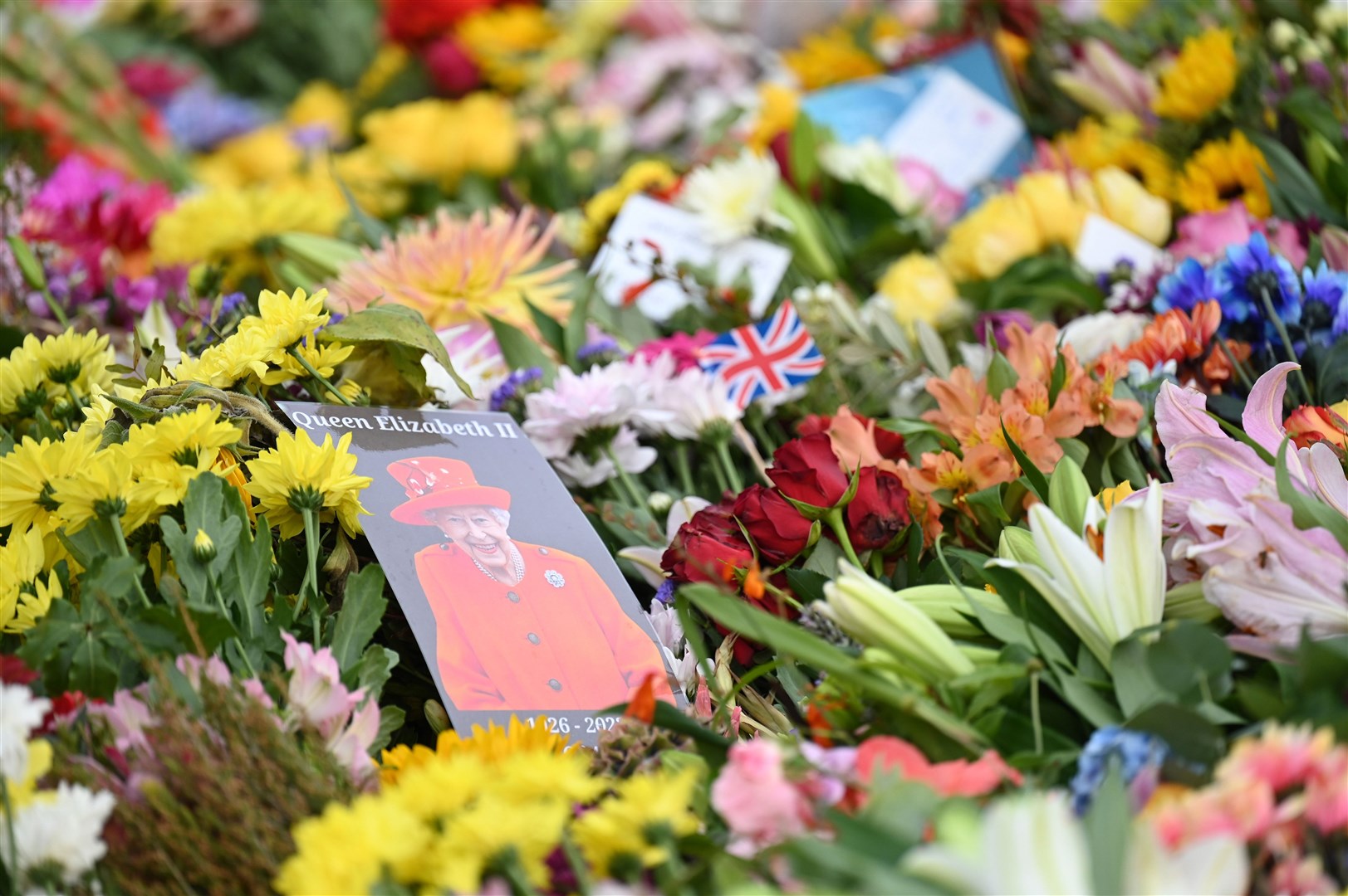 Among the floral tributes was a picture of the Queen (Michael Cooper/PA)
