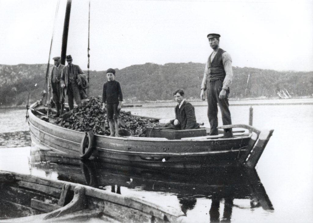 Coal boat (The Johann) unloading 10 tons of coal at Shieldaig in the late 1920s. Left to right: ?, Murdo Campbell (Lechnasaid), Ondie MacLean (boy), with older brother and father, Shondan. Picture courtesy of Gairloch Museum.