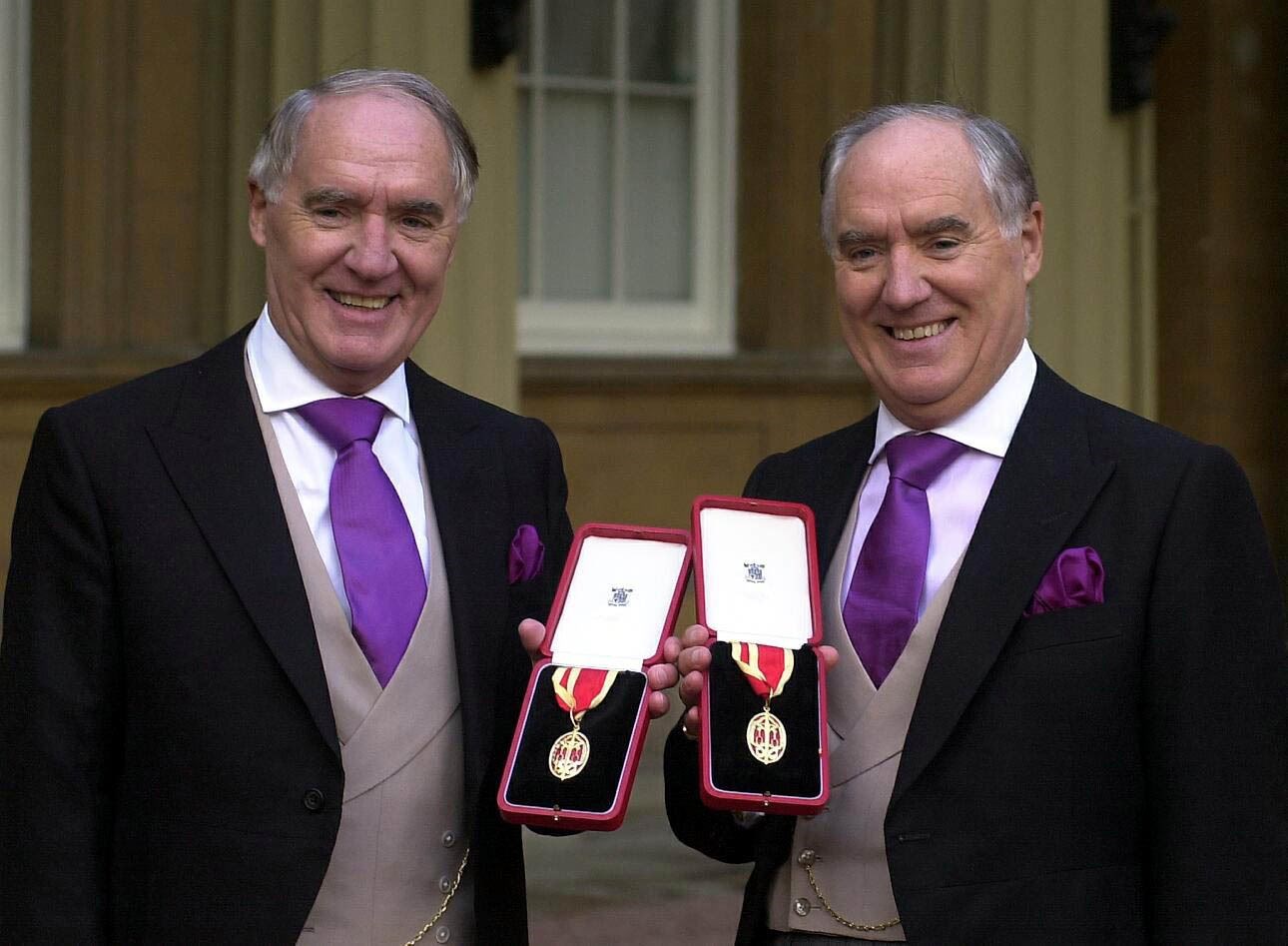 Sir David Barclay and his twin brother Sir Frederick after receiving their knighthoods from the Queen at Buckingham Palace (Michael Stephens/PA)