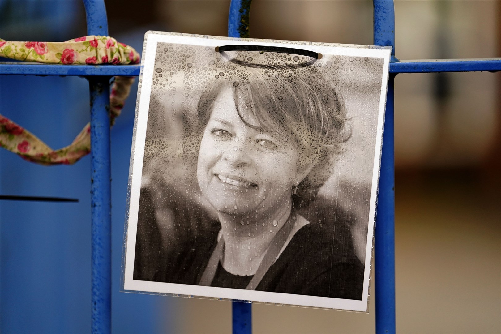A photograph of headteacher Ruth Perry attached to the fence outside her school in Berkshire (Andrew Matthews/PA)