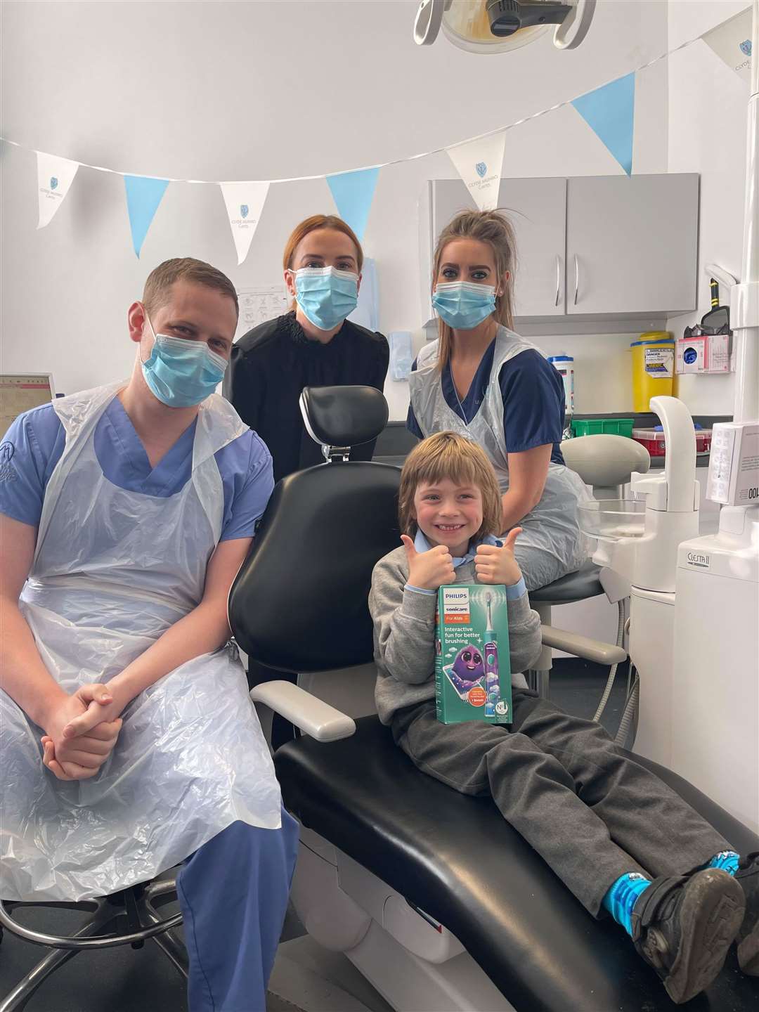 Dental team from left to right, James Dunaway, dentist, Courtney Forrester, practice manager, Louise Thomson, nurse, and Gabriel Schoenhofen, patient.