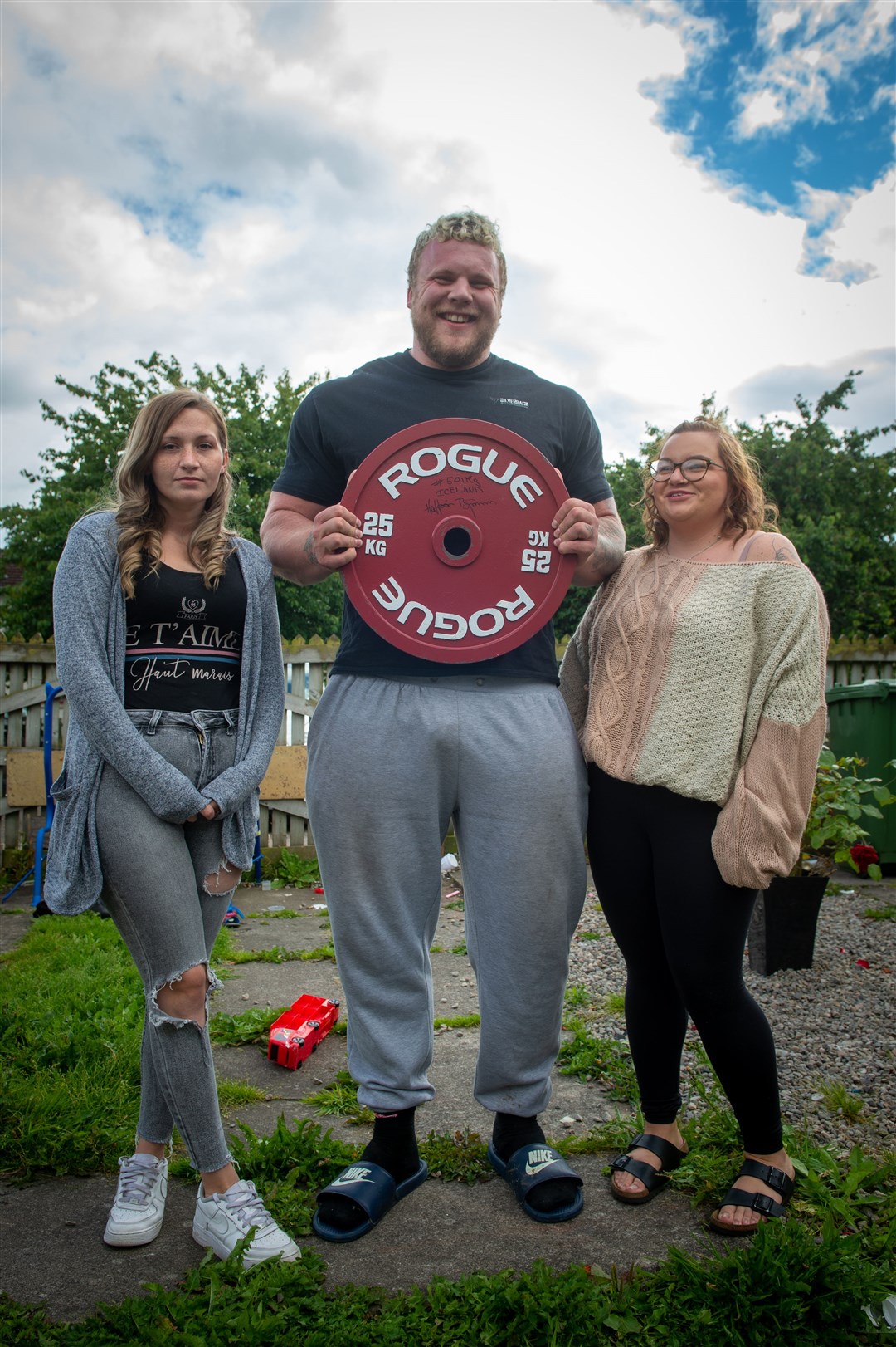 Sandie Tulloch, Tom and Sinead Stoltman are pictured with Hafthor Björnsson's donated 25kg plate. Picture: Callum Mackay.