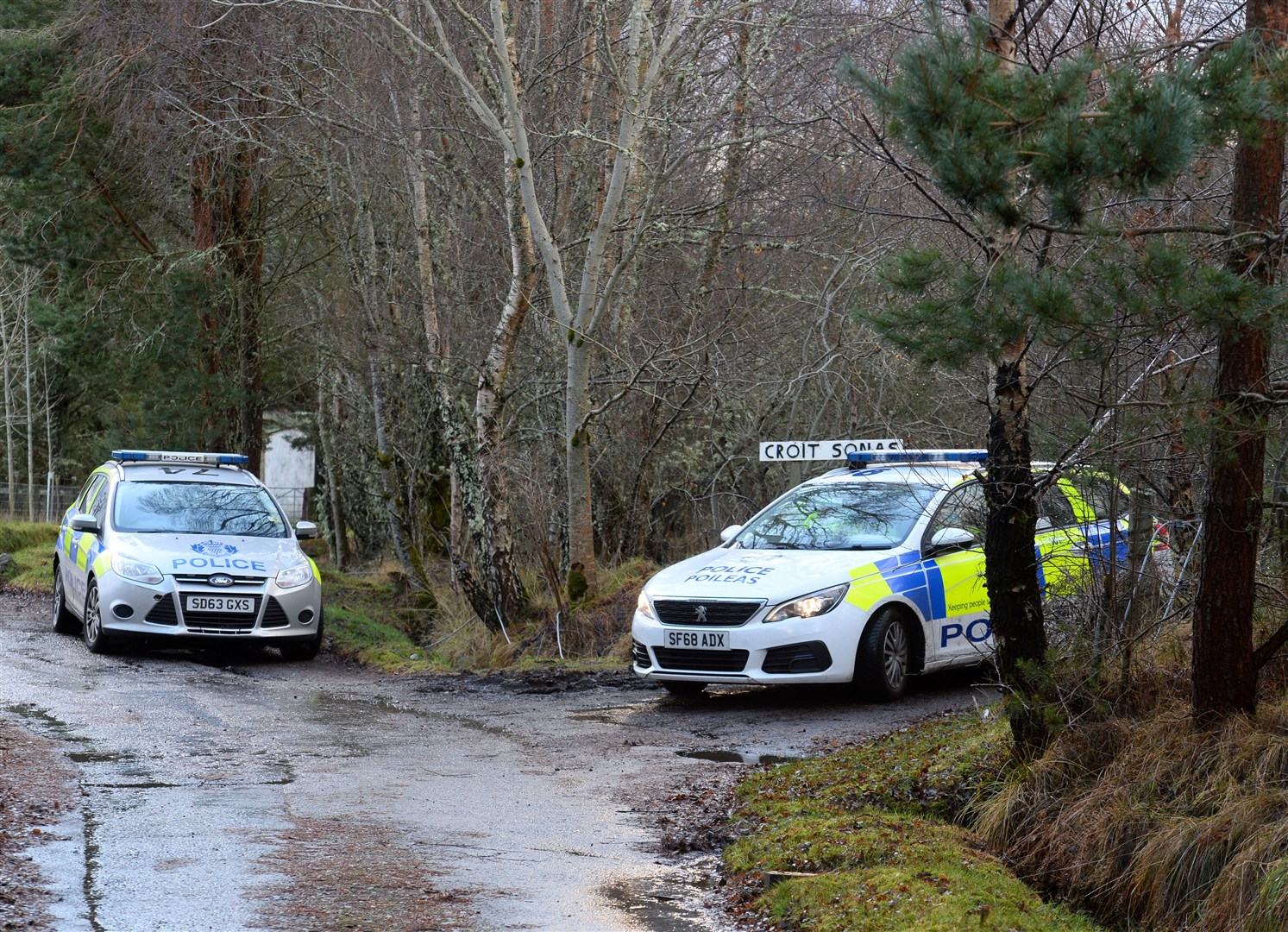 Police at entrance road to croft.