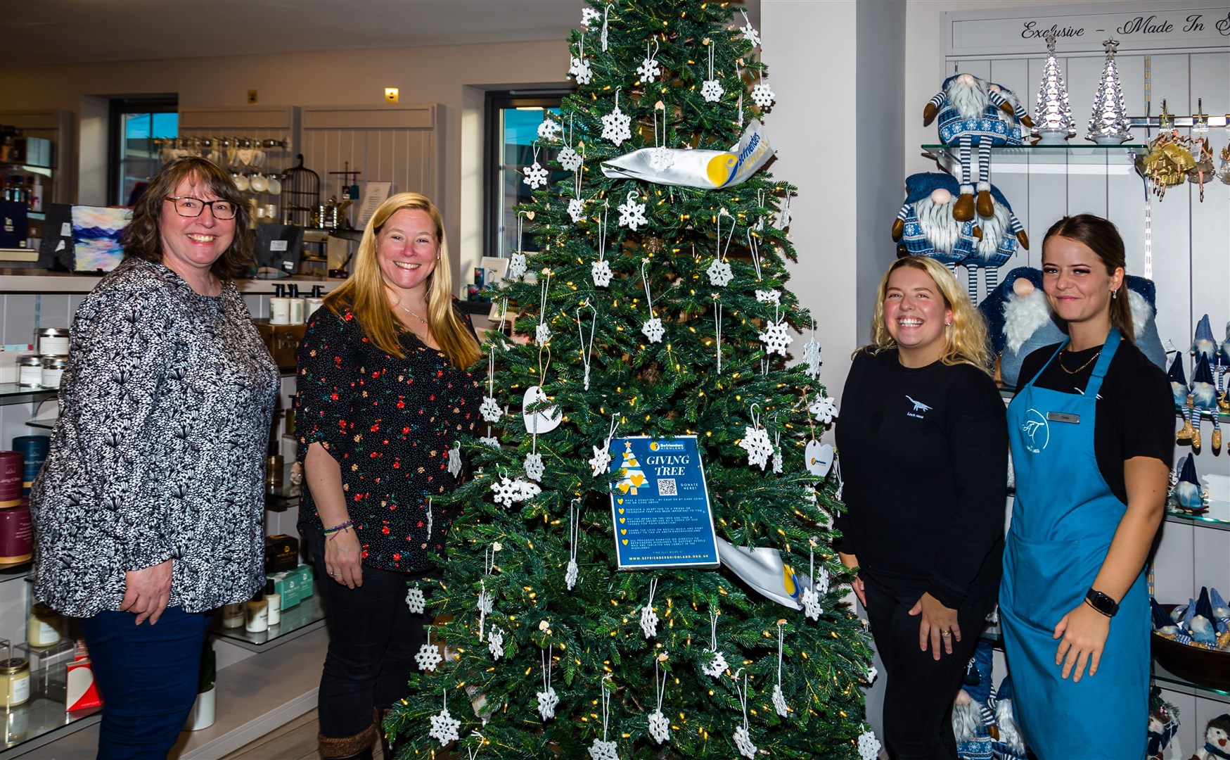 At the Giving Tree at An Talla are (from left) Susan White, executive director, Befrienders Highland, Jo Page, volunteer director, Befrienders Highland, Kelly Bruce, marketing manager, Jacobite/An Talla, and Caitlyn McLean, Jacobite team member.