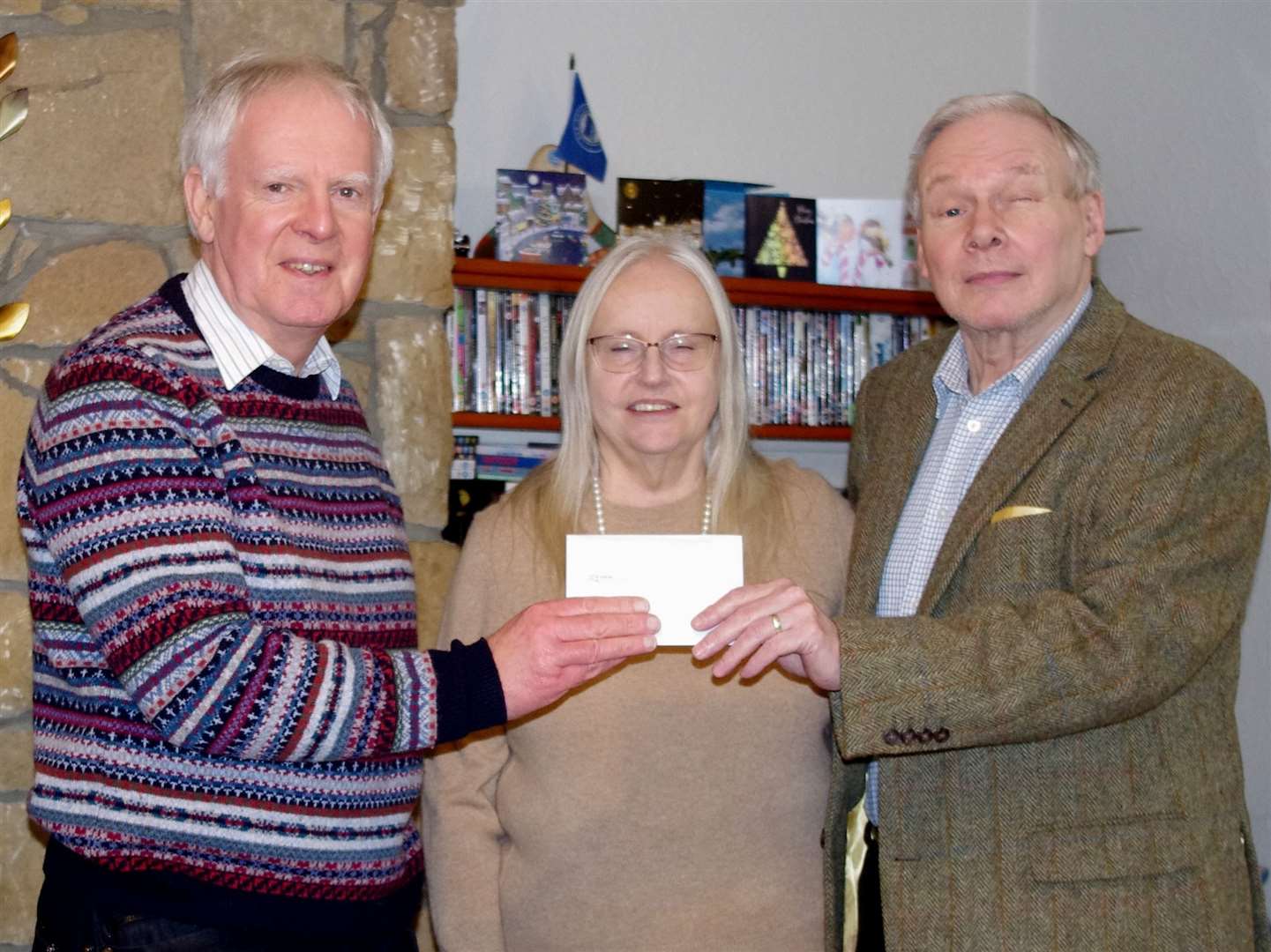 SSAFA Sutherland chairman William Sutherland (left) receiving the donation from Gordon and Jane Kenny.