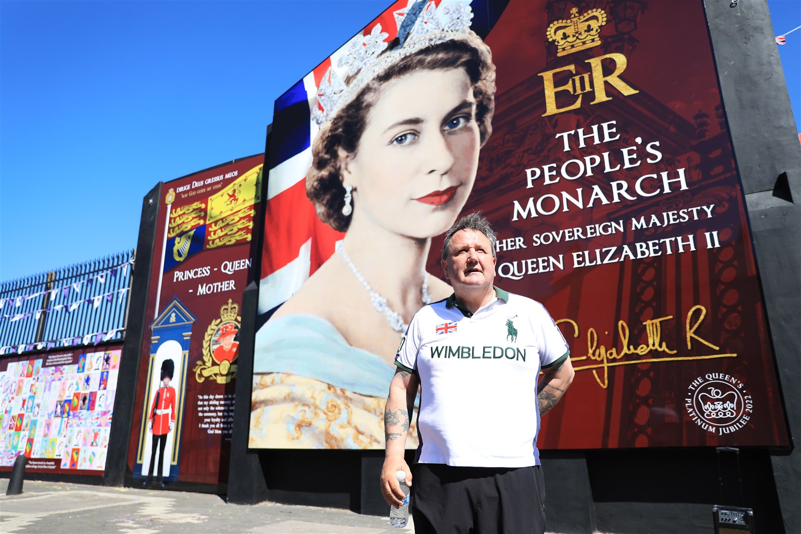 Gary Lenaghan beside the new Queen Elizabeth II mural on the Shankill Road (Peter Morrison/PA)