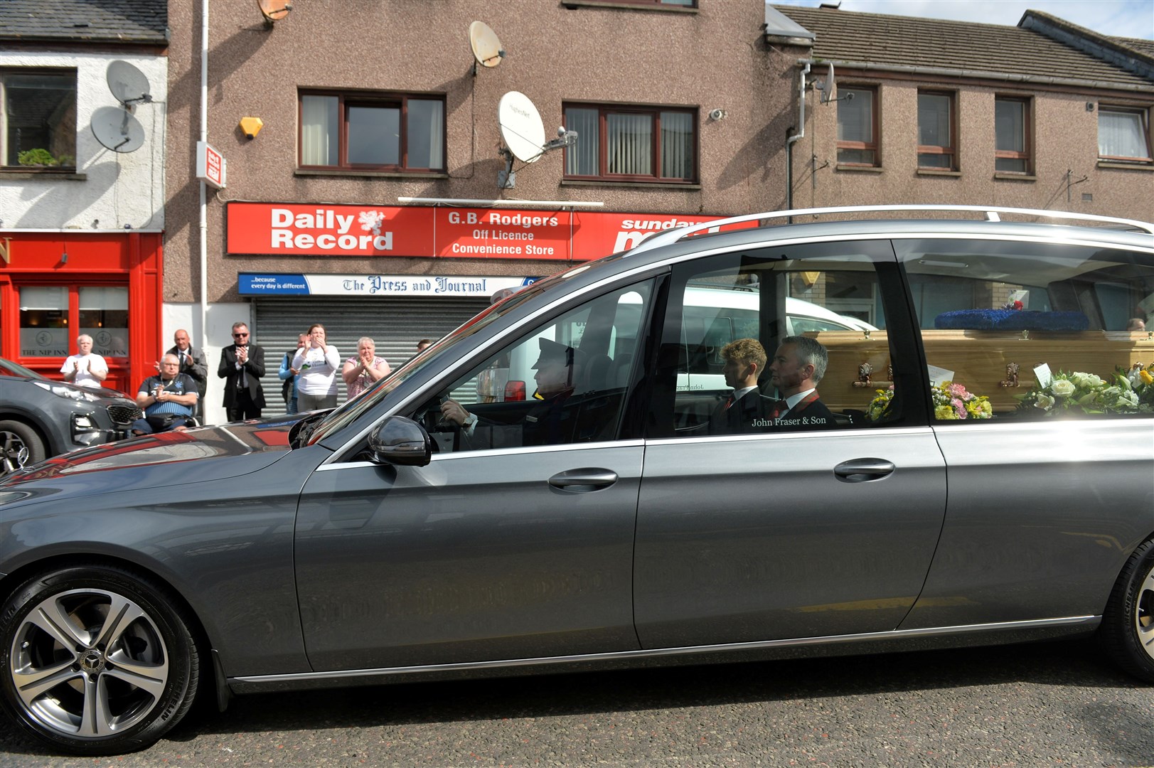 Mr Rodgers funeral procession stopped for a moment outside Rodgers Newsagents, where Mr Rodger was the fourth generation of his family to work at the Grant Street premises. Picture: Callum Mackay
