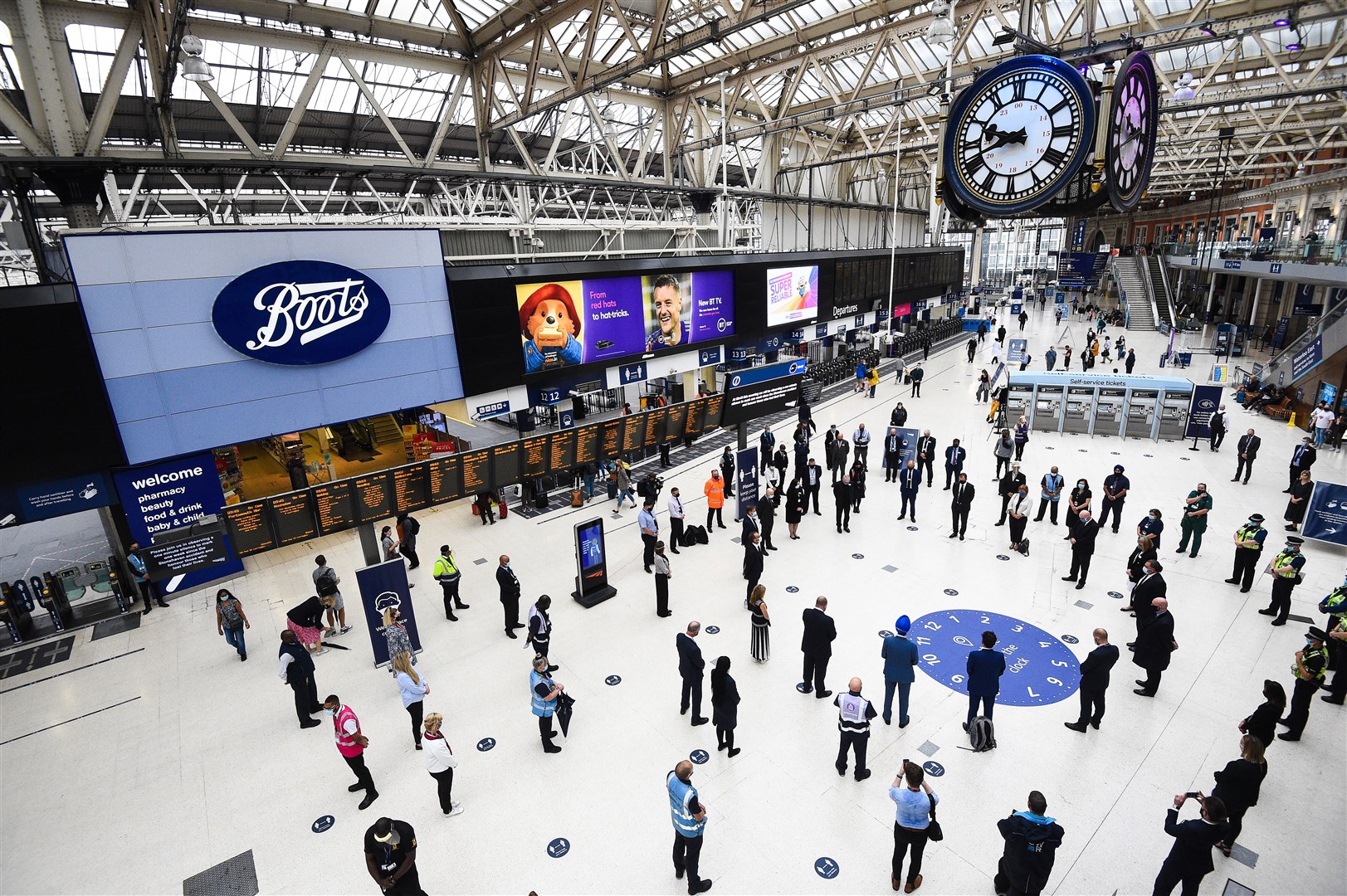 Rail staff stand pay tribute at Waterloo station in London (Kirsty O’Connor/PA)
