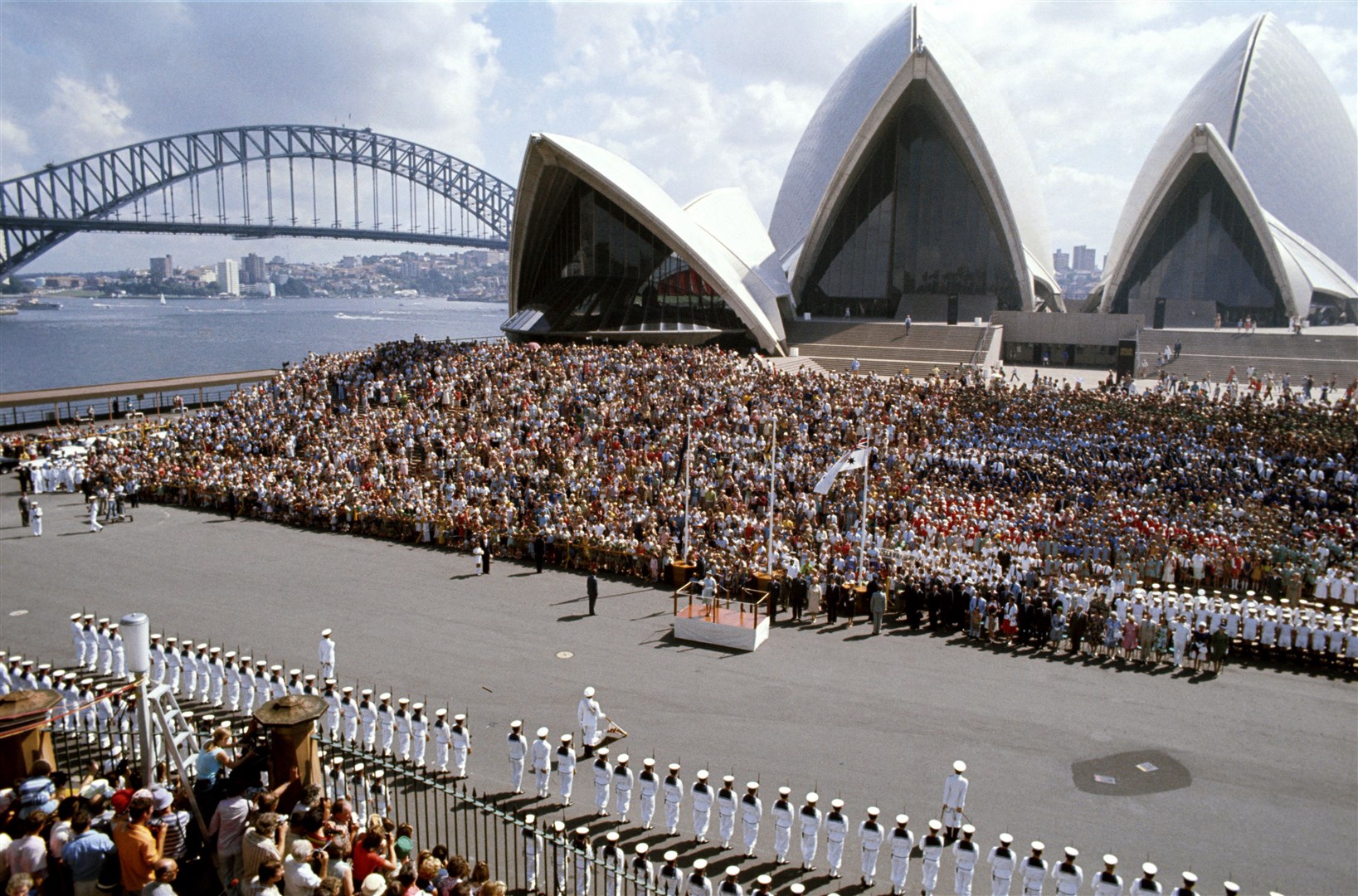 The Sydney Opera House, with the Harbour Bridge in the background, during the Queen’s 1977 visit to Australia (Ben Roll/PA)