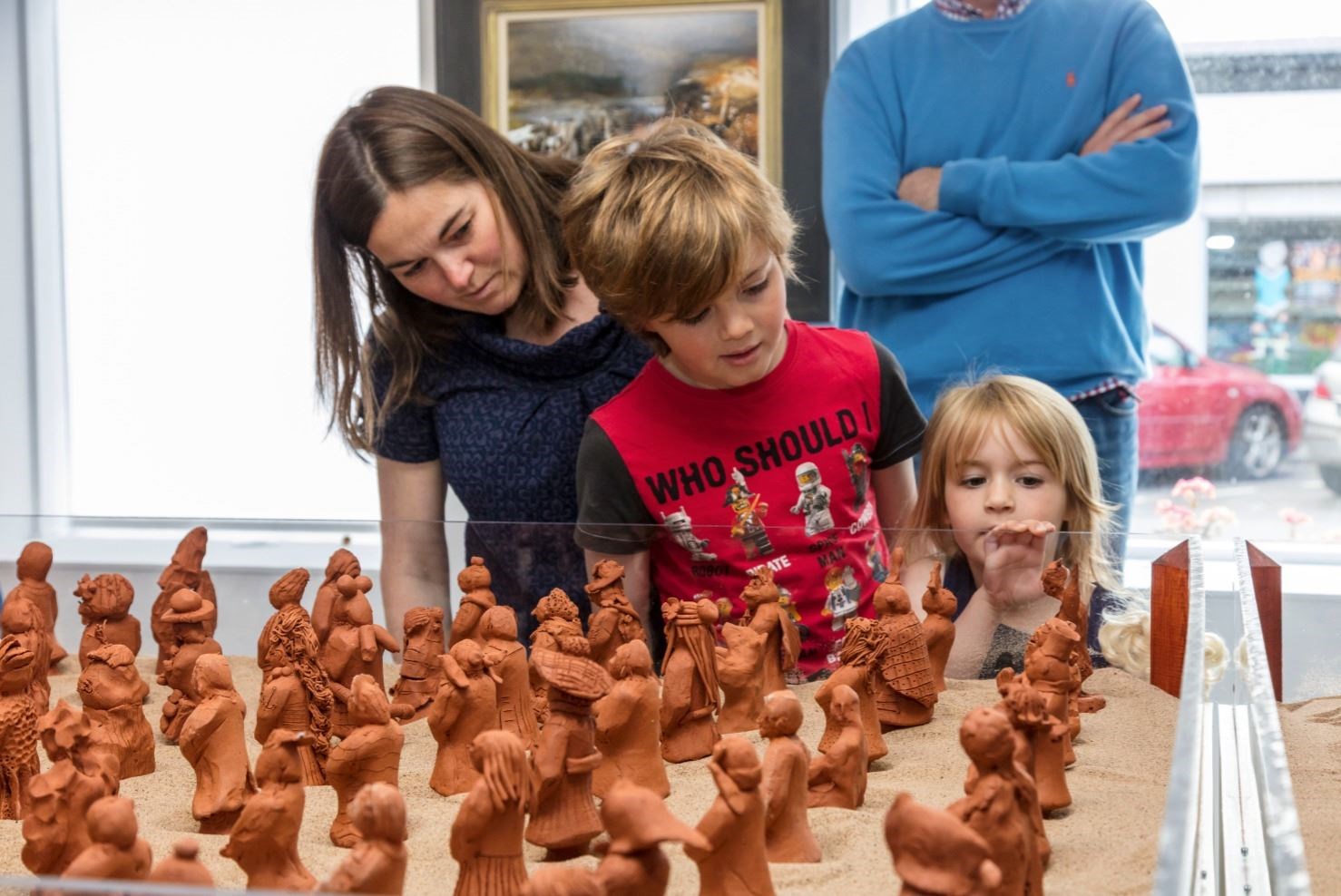 A family views a Tiny Terracotta Army display at the gallery. Picture: Steven Gourlay.