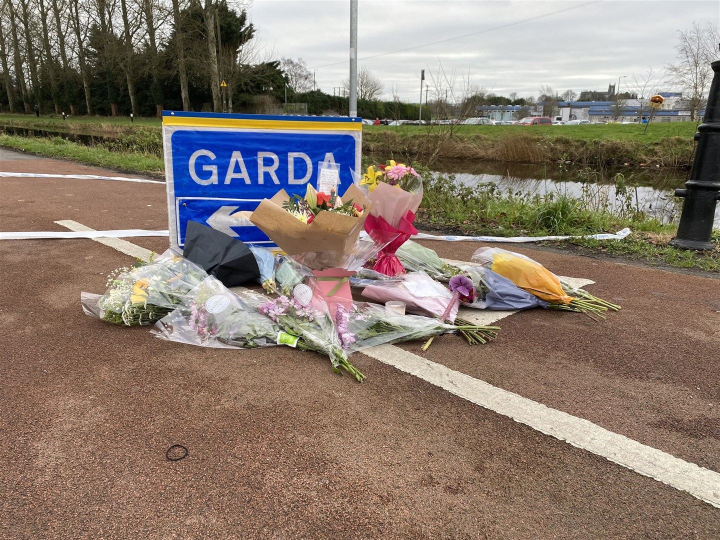 Flowers and messages left at a Garda checkpoint in Tullamore after Ashling Murphy was killed while jogging along a canal bank (Dominic McGrath/PA)