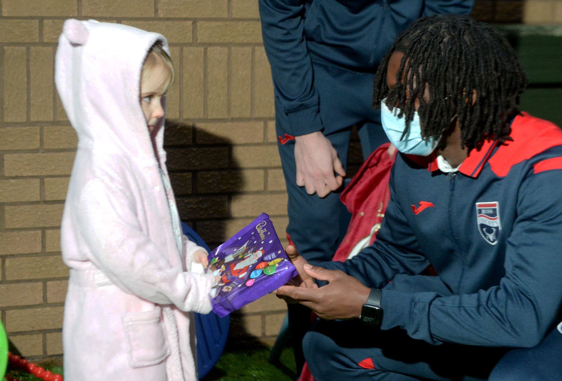 Ali receives a selection box from Joseph Hungbo. Picture: James Mackenzie.