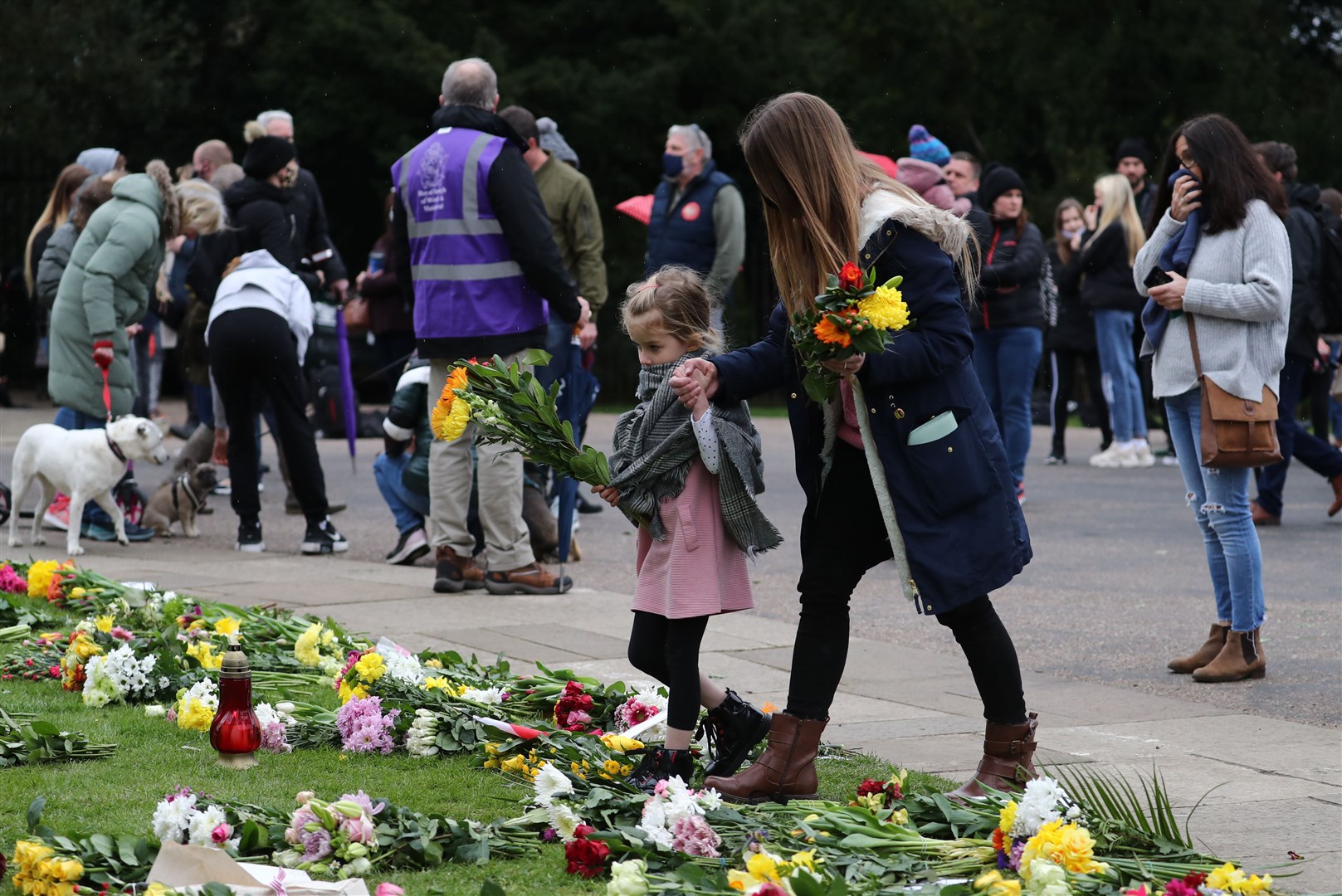 People leave flowers outside Windsor Castle on Saturday (Gareth Fuller/PA)