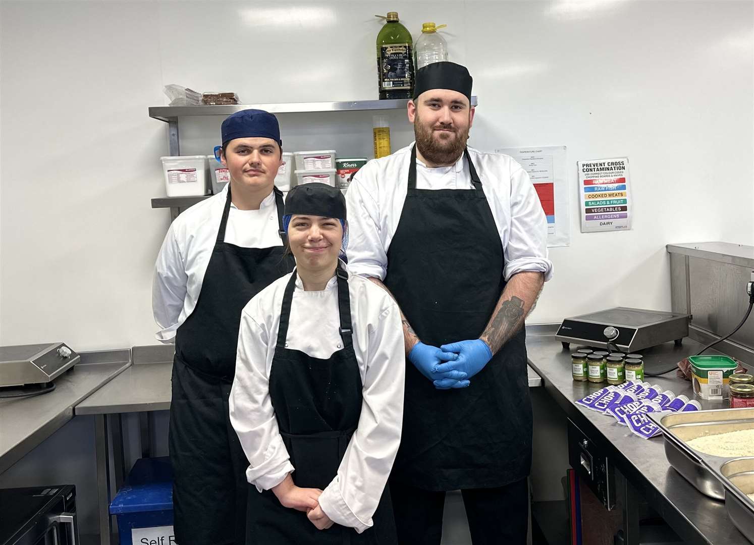 Professional Cookery students (front) Maria Ahmadulina and (back from left) Max McKeever and James Durning getting ready to prepare the next batch of Food for Families meals.