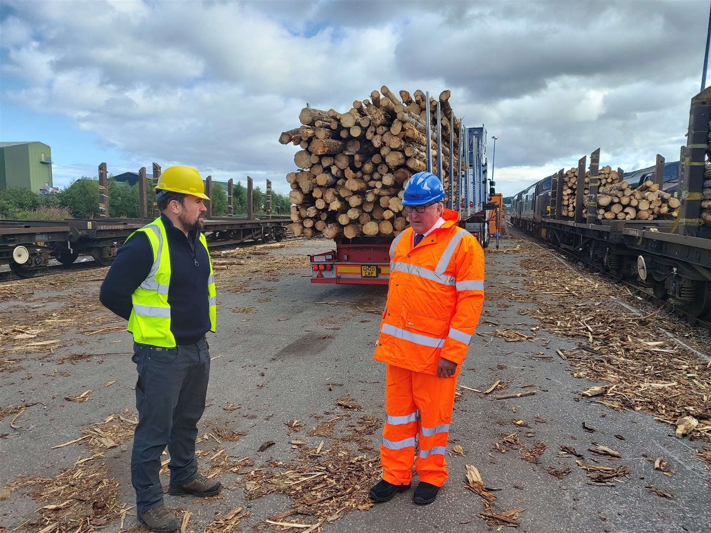 Matthew Thompson of Munro Harvesting (left) discusses the Timber by Rail project with Rural Economy Secretary Fergus Ewing at the Inverness Yard.