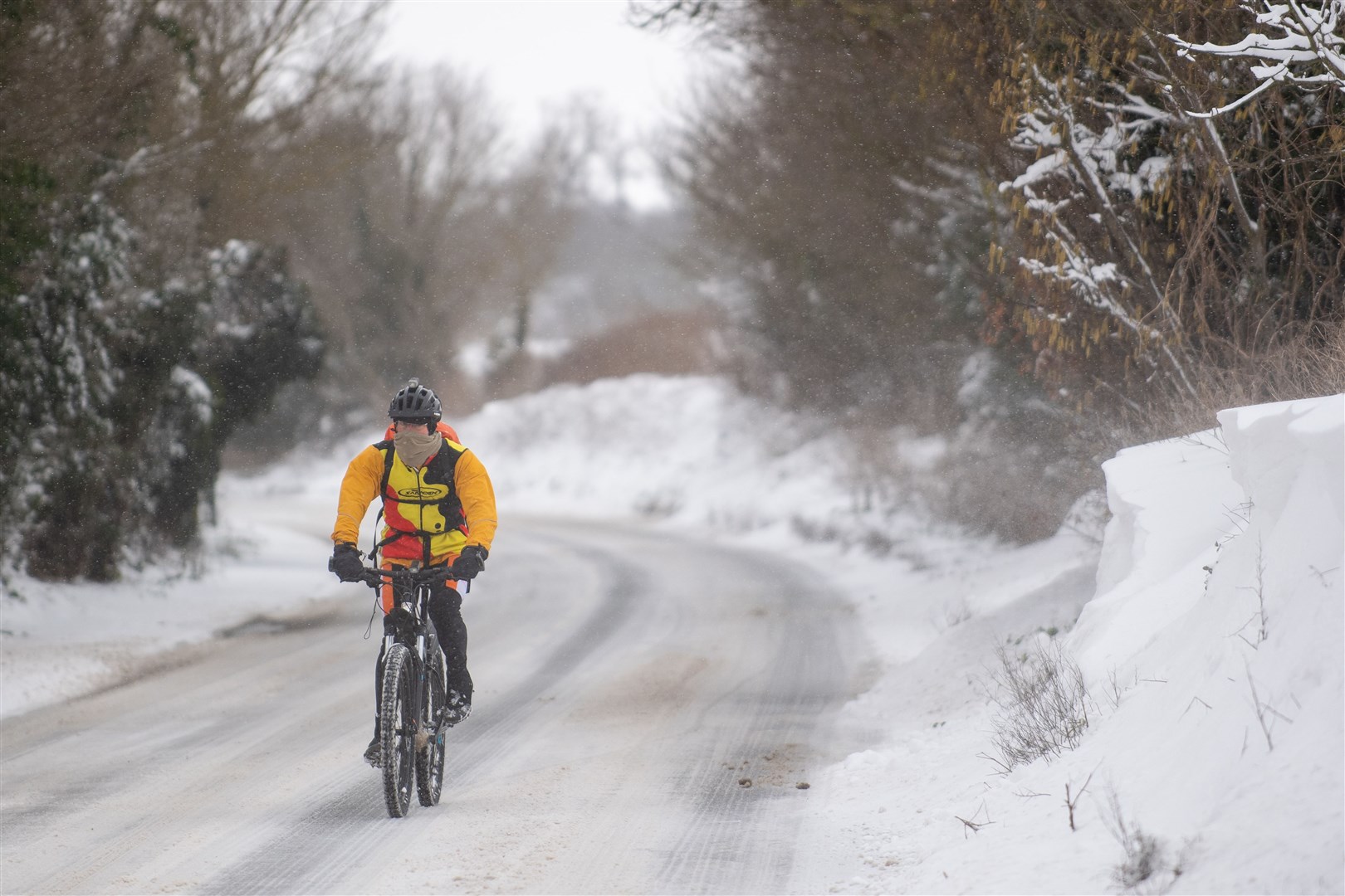 A cyclist makes his way through snow in Barham, near Ipswich (Joe Giddens/PA)