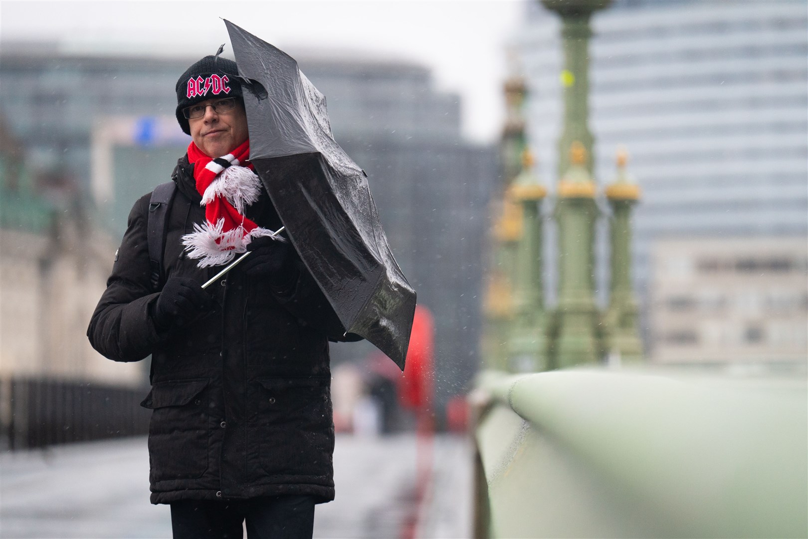 A pedestrian bracing against the wind and rain as they walk along Westminster Bridge, central London, on Tuesday (James Manning/PA)