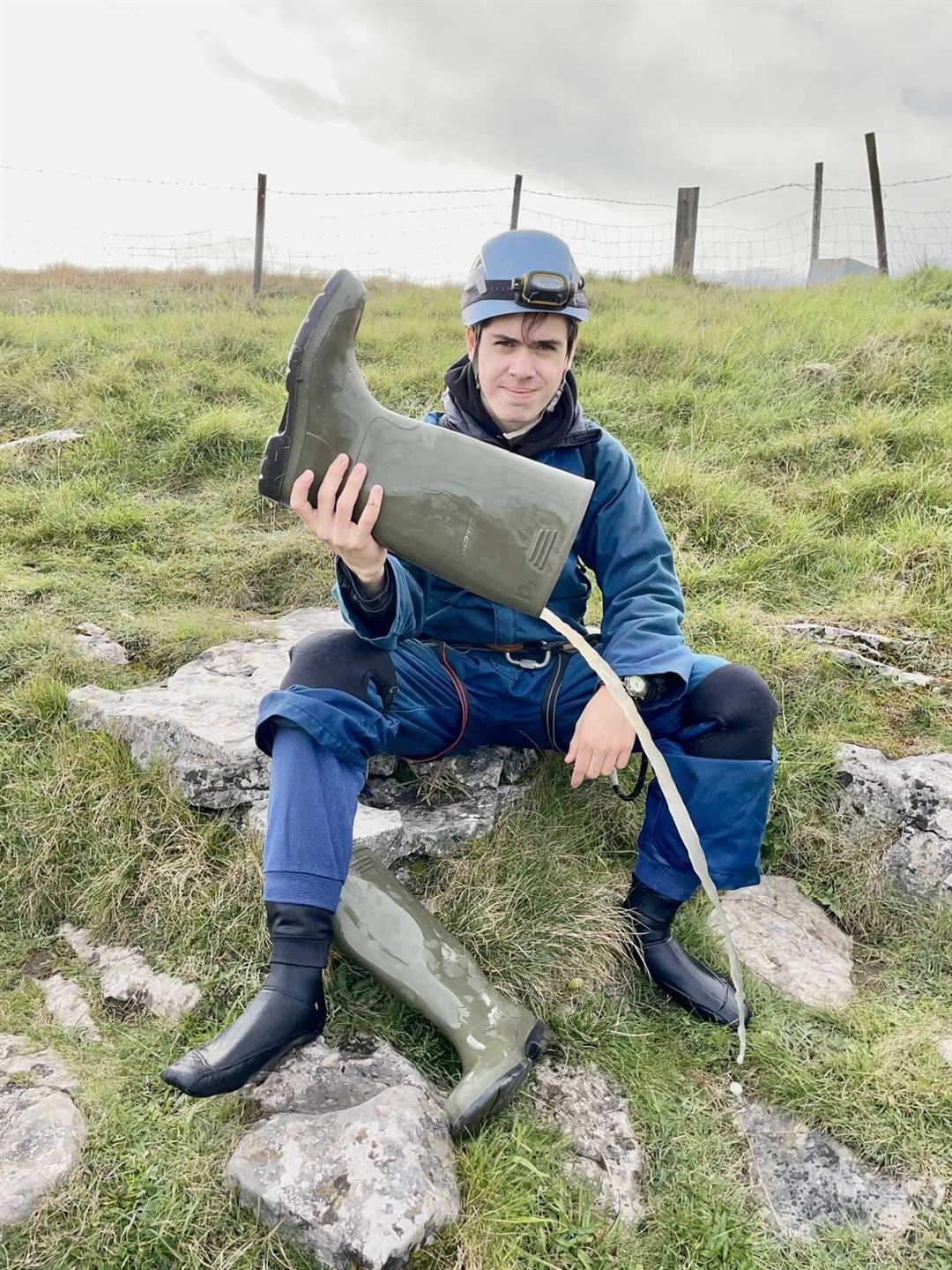 Cadet Lance Corporal Lucus Macrae, from 1st Battalion The Highlanders’ Alness Detachment, gets the water out of his wellies after his caving experience in Lancaster