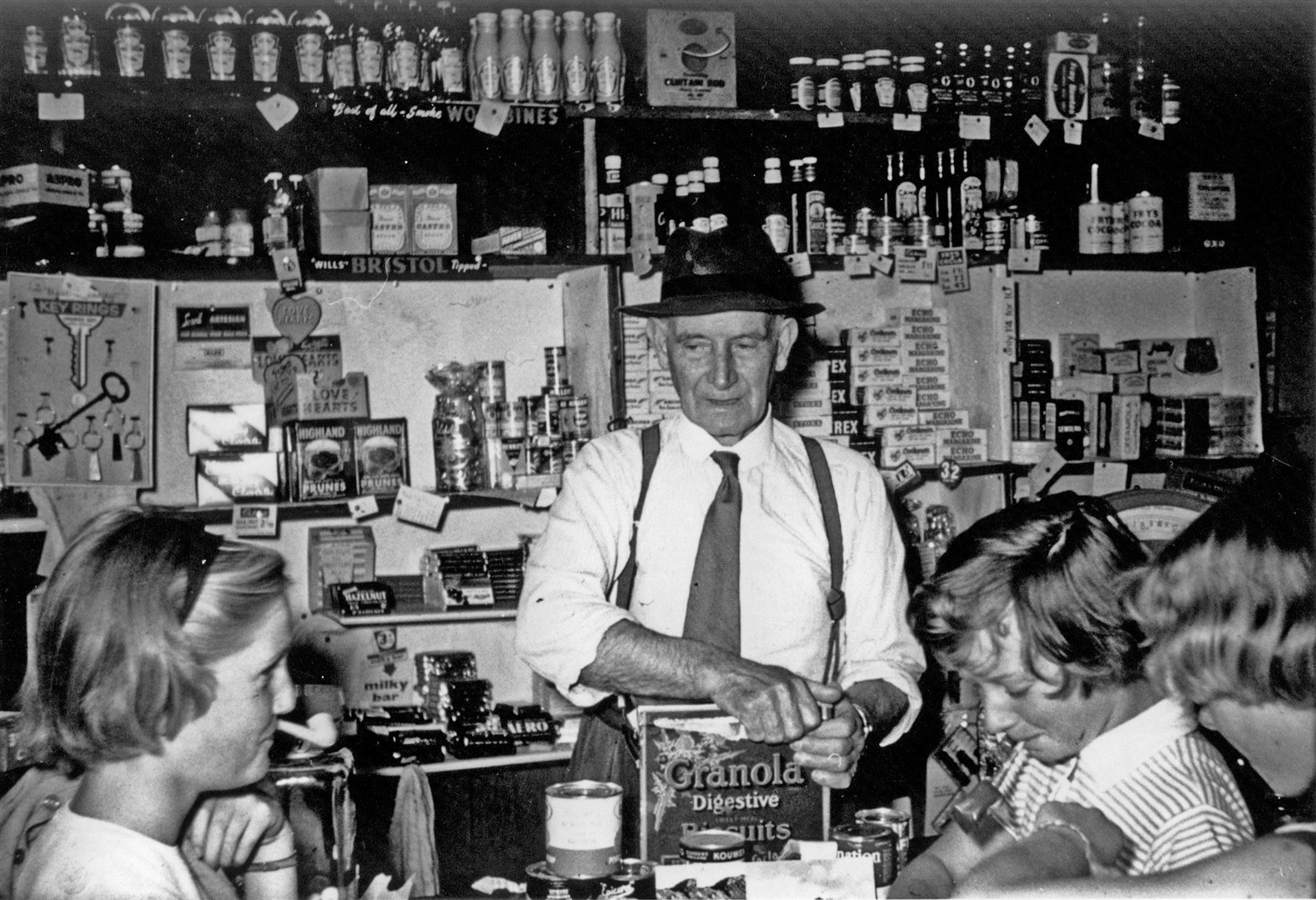 Roddie MacLean ‘Ruairidh Shildeag’ at the counter of his shop in Badachro, 1961