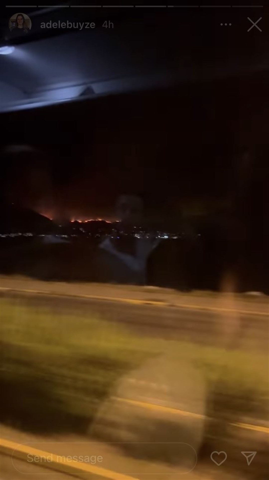 A line of flames on the hillside, as photographed from the bus during evacuation