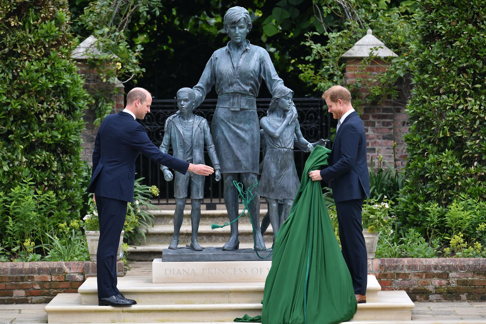 The Duke of Cambridge and the Duke of Sussex unveiling a statue they commissioned of their mother in 2021 (Dominic Lipinski/PA)