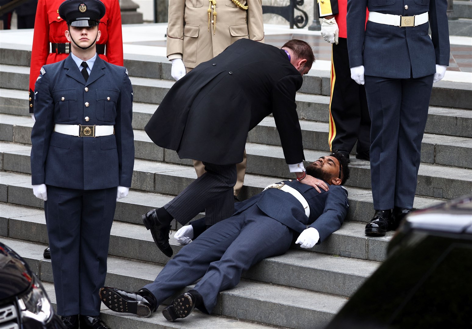 While another guardsman fainted and had to be helped away (Henry Nicholls/PA)