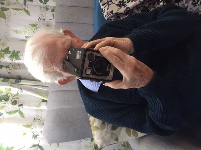 A care home resident using a camera from one of the memory boxes (Wessex Heritage Trust/PA)