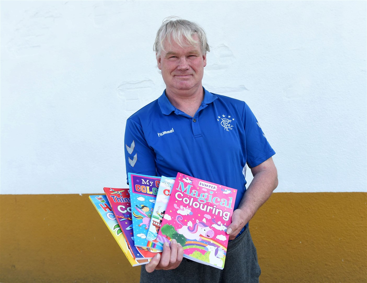 Martin Macdougall used his holiday money to give away free colouring books to help out parents who are struggling to keep kids busy. Picture: Callum Mackay