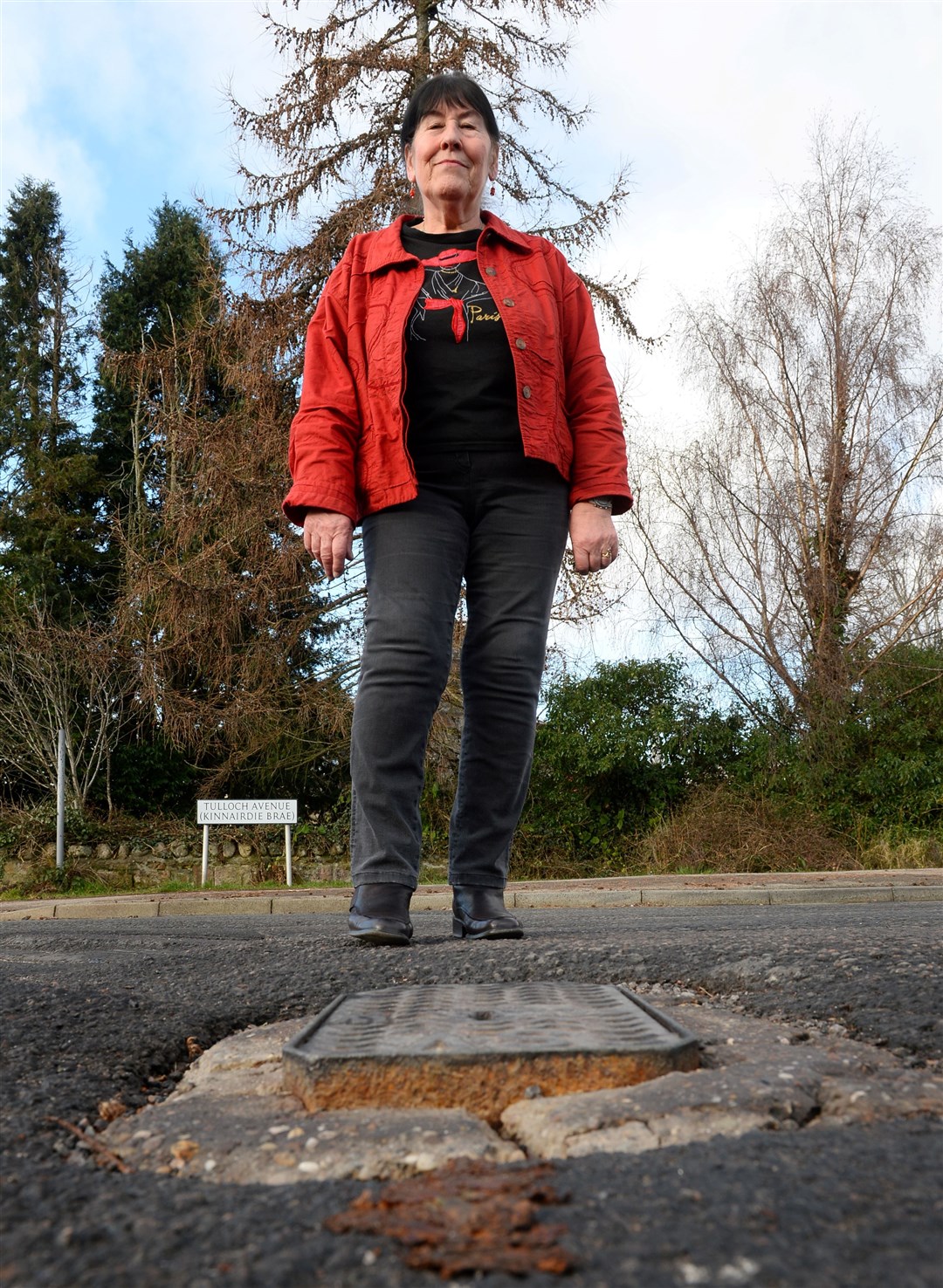 Cllr Margaret Paterson at raised ironwork in pothole at traffic lights on Tulloch Avenue Dingwall.Picture Gary Anthony.