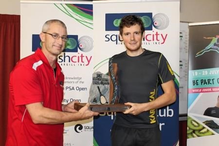 Squash City Club president Grant Small presents Greg Lobban with the Southern Open trophy.