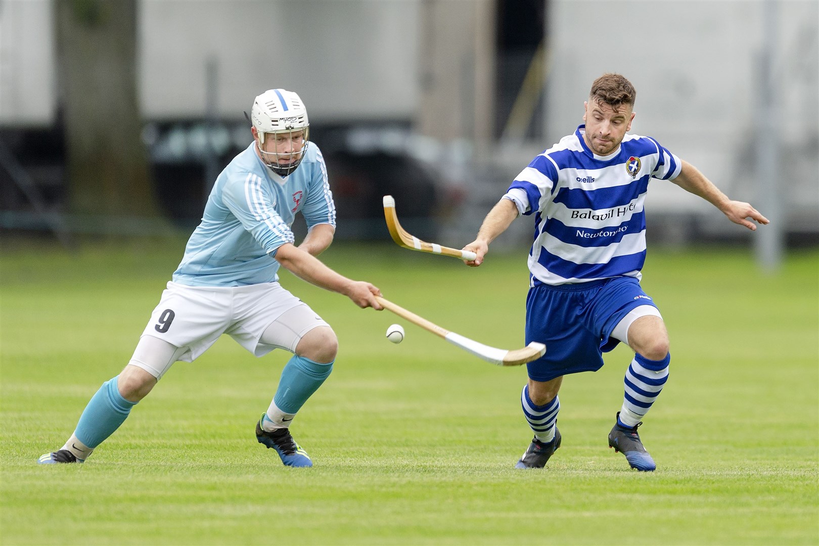 Liam Symonds (Caberfeidh) with Drew Macdonald (Newtonmore). Newtonmore v Caberfeidh in the Tulloch Homes Camanachd Cup semi final, played at The Bught, Inverness.
