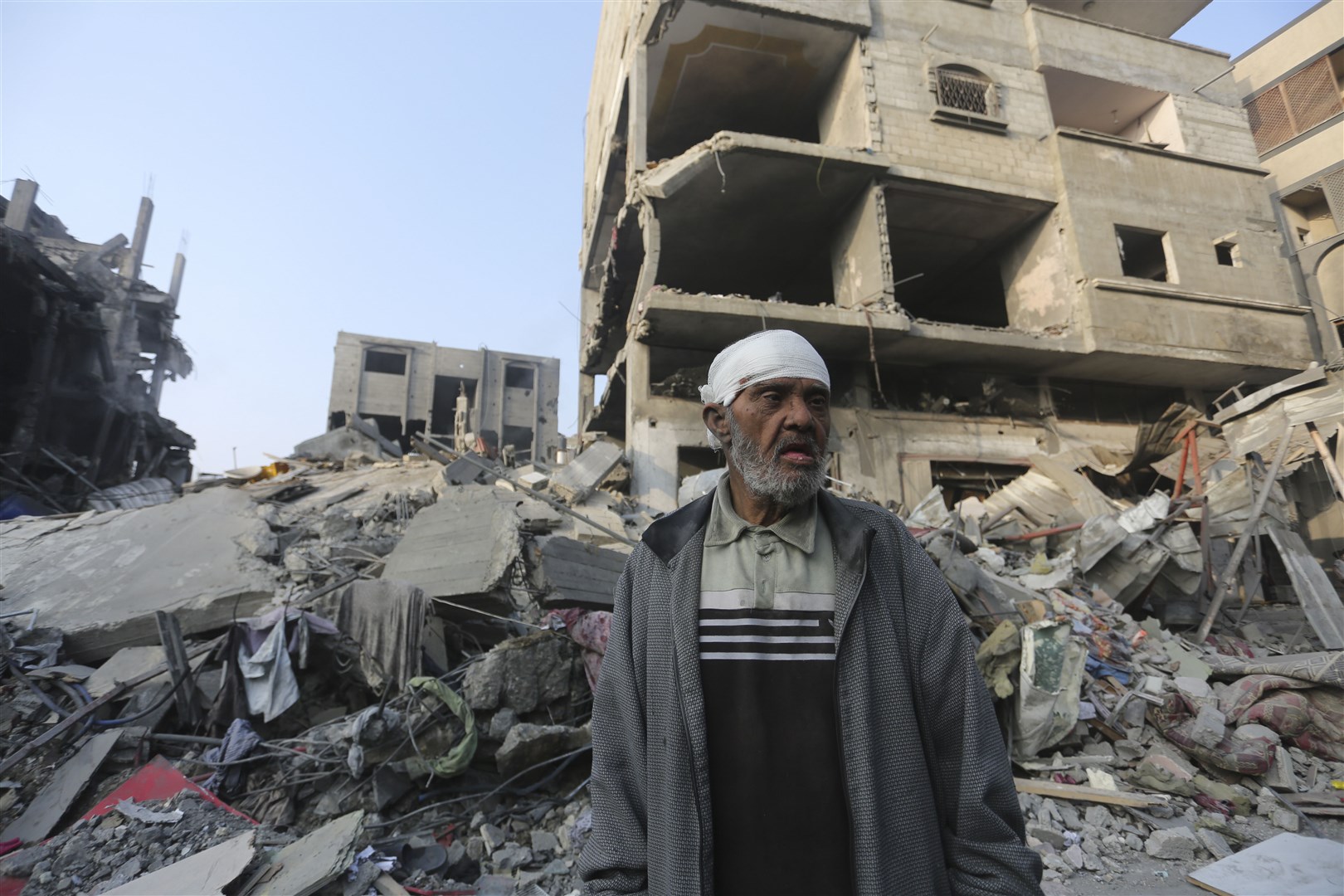 A Palestinian stands outside a building destroyed during an Israeli bombardment of the Gaza Strip in Rafah (Hatem Ali/AP/PA)