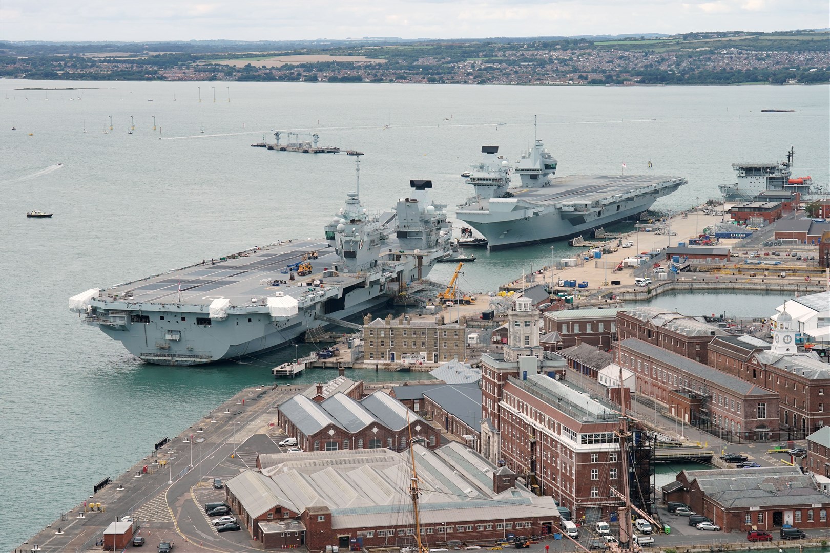 HMS Prince of Wales berths alongside HMS Queen Elizabeth at Portsmouth Naval Base (Jonathan Brady/PA)
