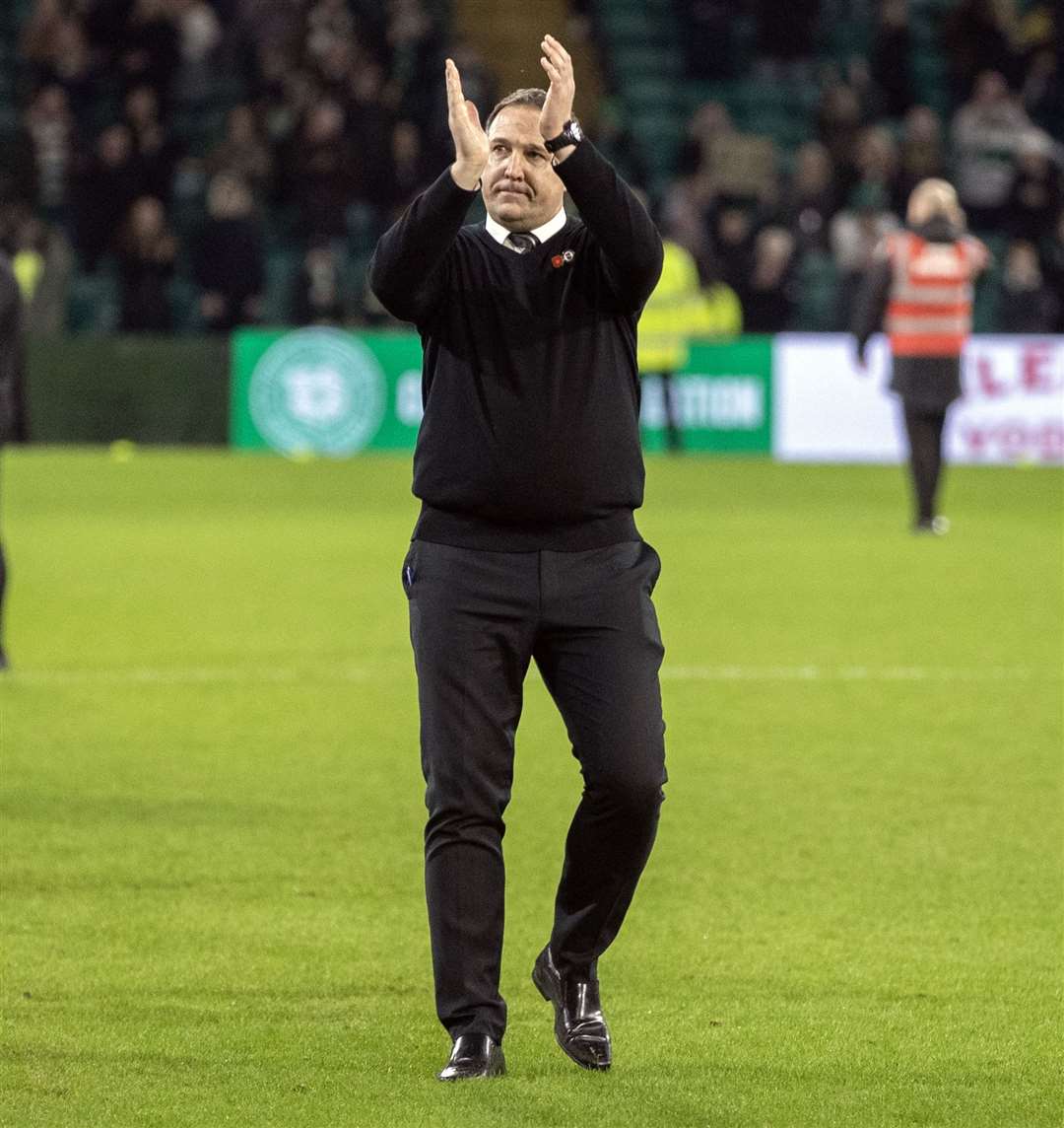 Malky Mackay applauds fans after a narrow defeat at Celtic Park