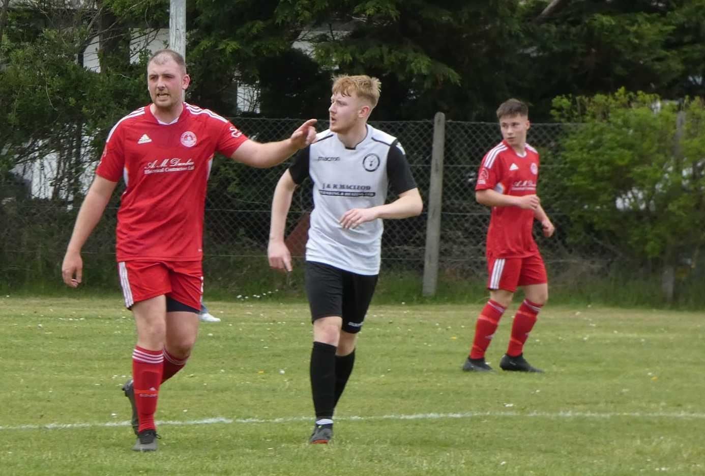 Robert Fisher (Brora Wanderers) and Ryan Ross (Social Club) in action.