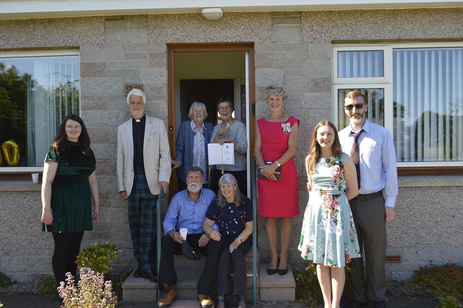 Jenny Rae (granddaughter), Rev James Currall Scottish Episcopal Church, Barbara Rae, Pat Rae (daughter, holding Royal card), Joanie Whiteford, Heather Cochrane (granddaughter) and Euan Cochrane. Front Ian Rae (son) and Jane Rae.