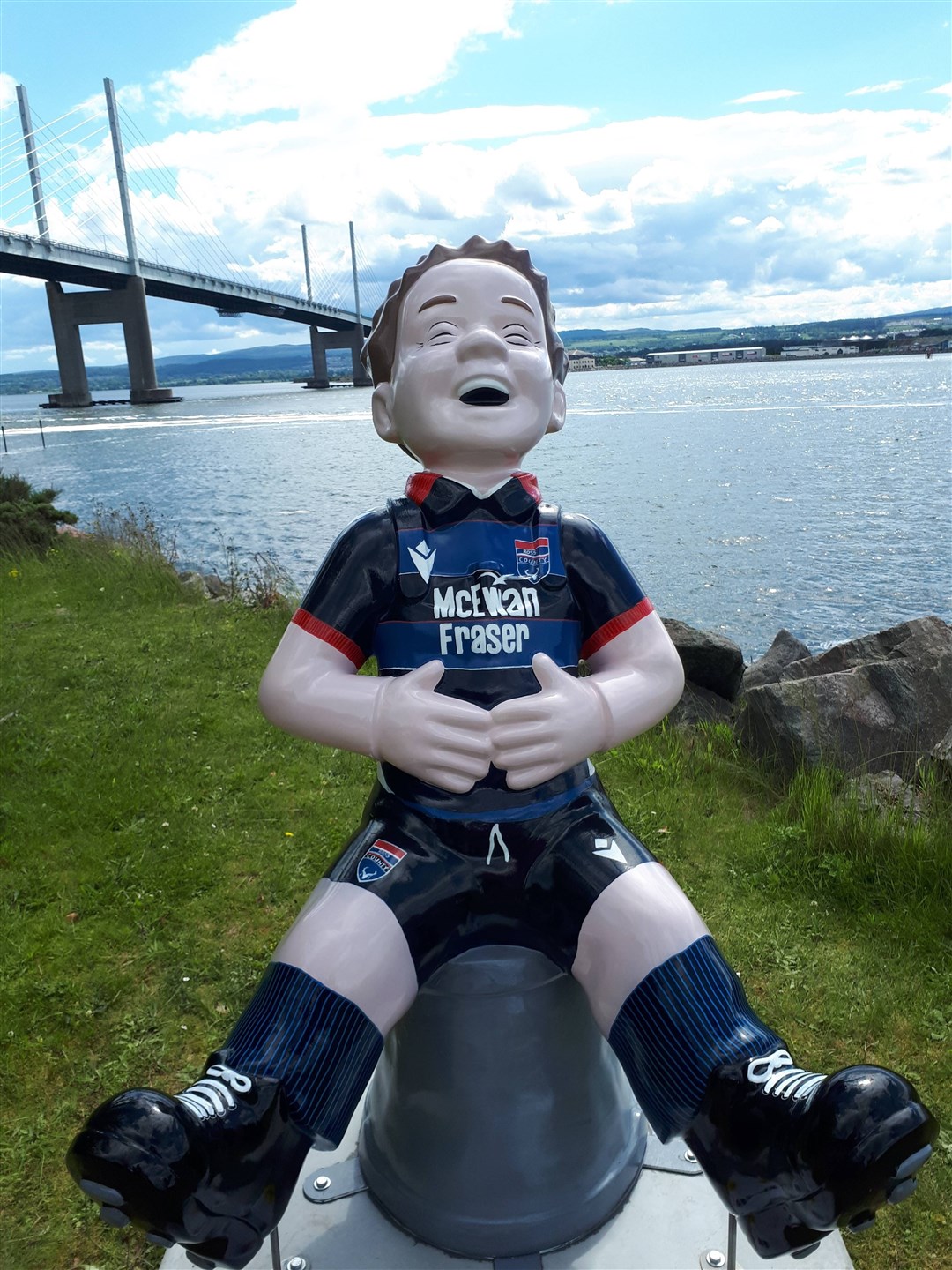 Oor Wullie decked out in Ross County colours with a familiar Kessock Bridge landmark as a backdrop