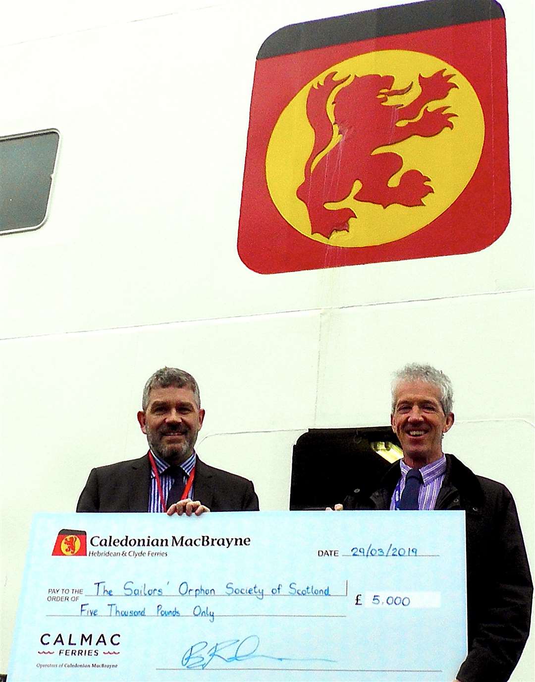 CalMac’s director of community and stakeholder relations Brian Fulton (left)) presents the donation to Society Chairman, Michael Abram.