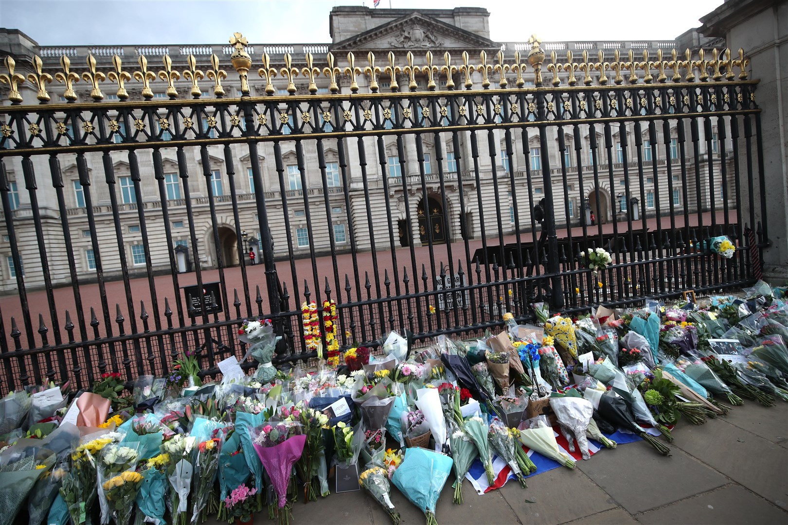 Flowers have been left outside Buckingham Palace (Yui Mok/PA)