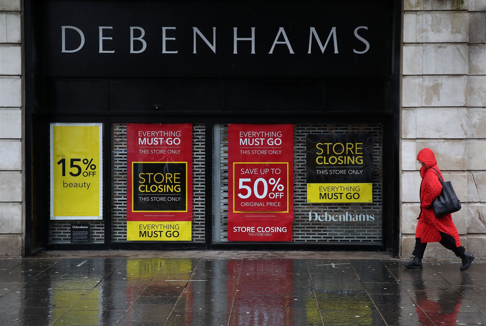 A person walks passed a Debenhams store in Glasgow (Andrew Milligan/PA)