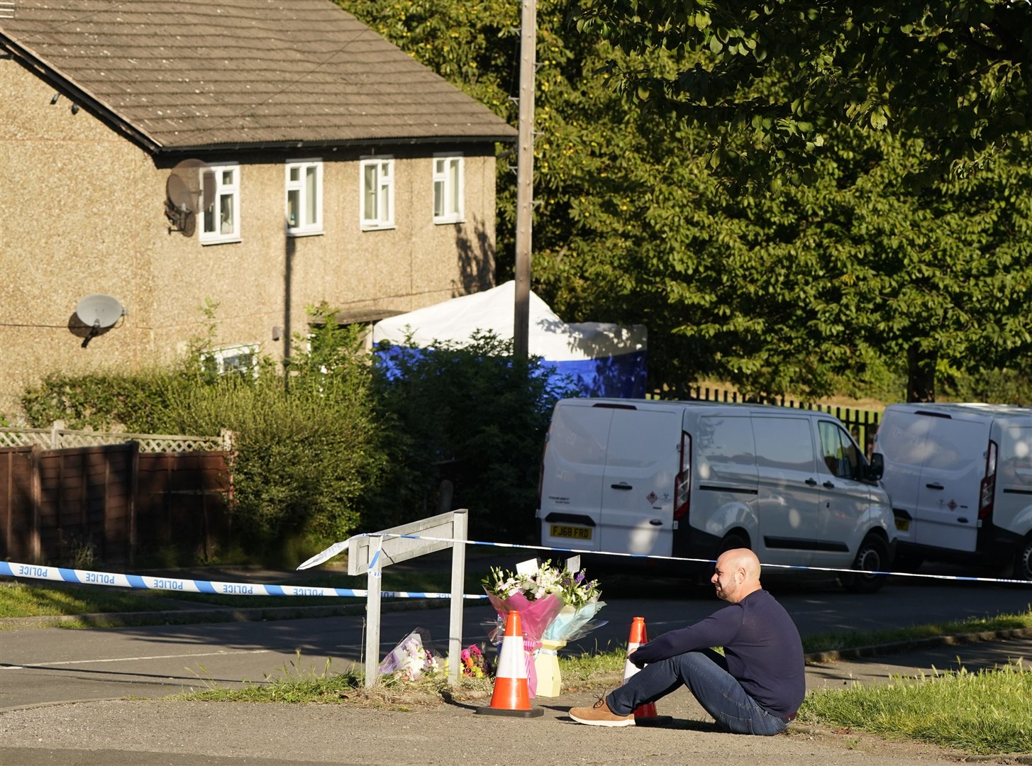 The father to some of the victims leaves flowers at the scene (Danny Lawson/PA)