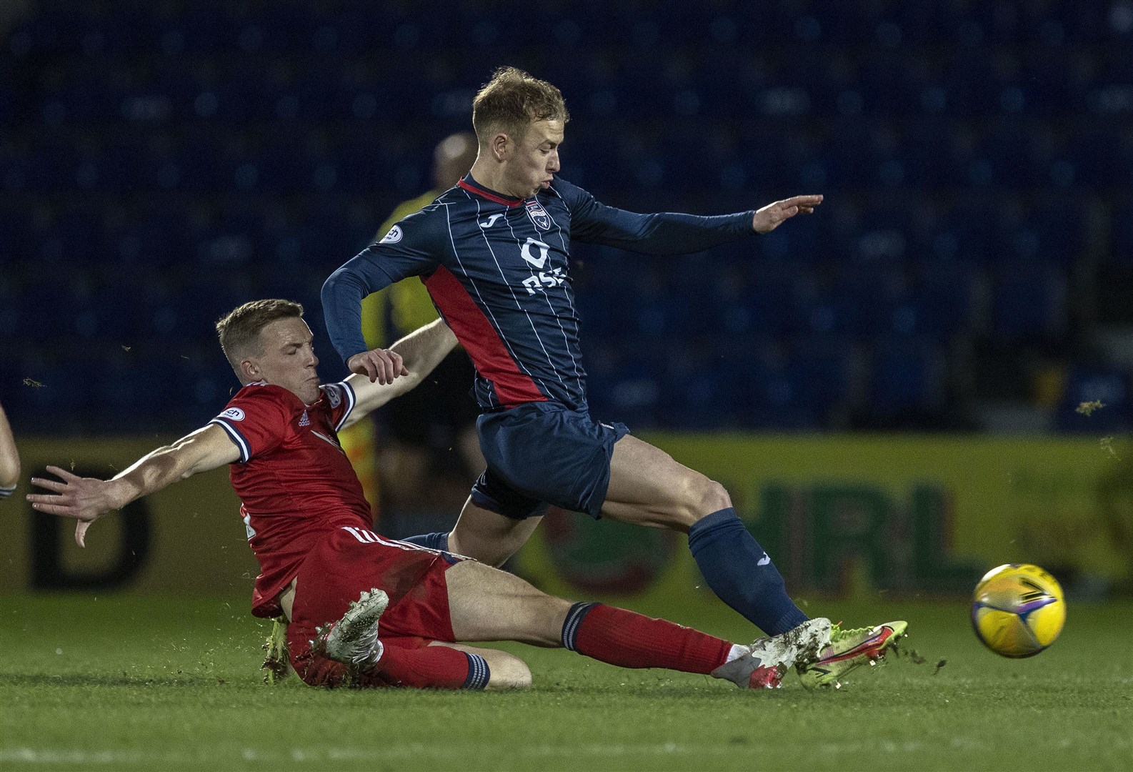 Ross County's Harry Paton was brought crashing down from this challenge from Aberdeen's Lewis Ferguson. Picture: Ken Macpherson